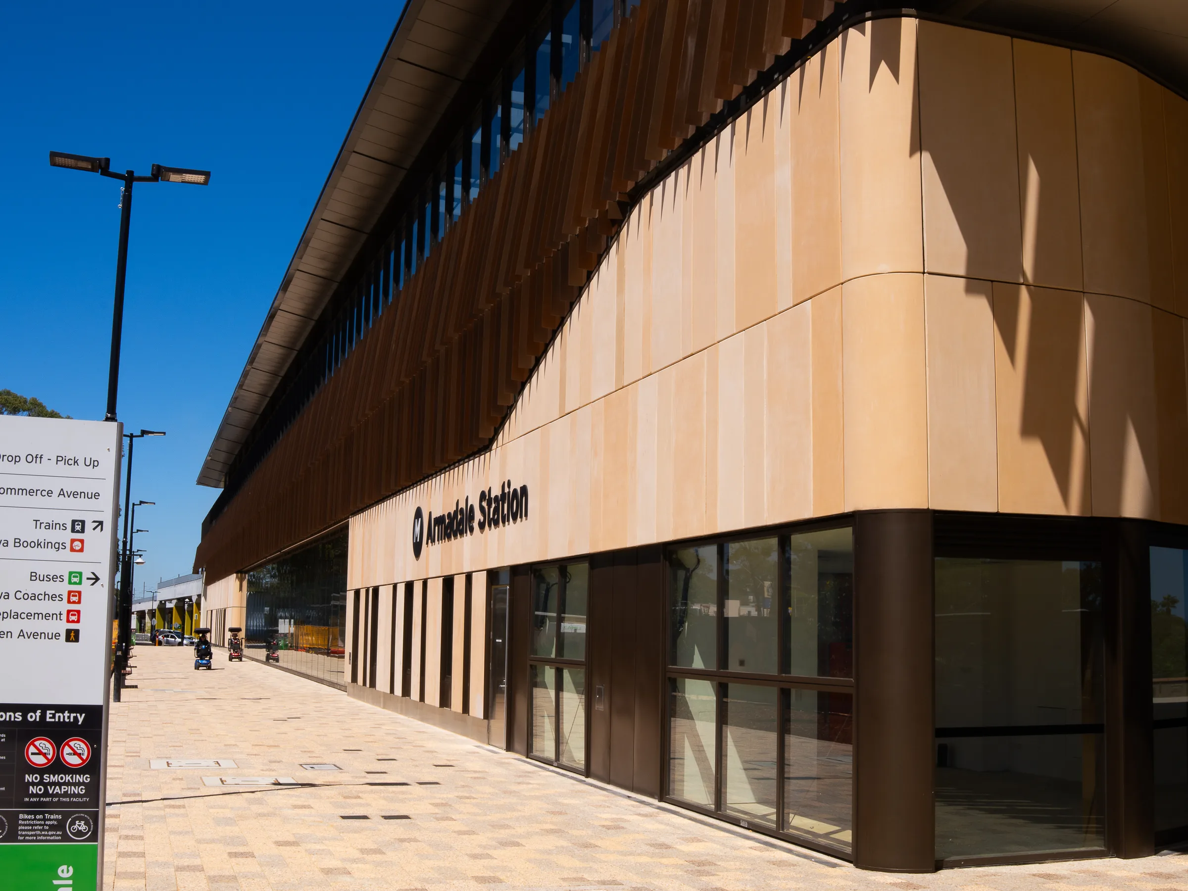 The bronze-clad curve of Armadale Station above a dark glazed base